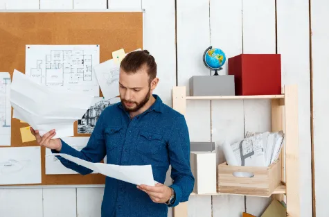 young man looking at results of property inspection in an office